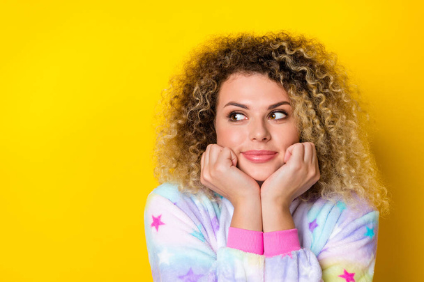 Portrait of attractive minded wavy-haired girl in pajama ponder copy space isolated over vibrant yellow color background - Fotoğraf, Görsel