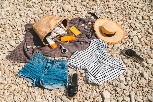 ビーチの物のオーバーヘッドビューは、バッグフラットレイと太陽の保護クリームストロー帽子で毛布 - 写真・画像