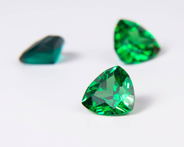 Elegant emerald green stone diamond jewelry on the white - Фото, изображение
