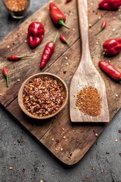 Variety of fresh and dried chili peppers on rustic background - Foto, Imagen