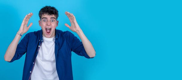 young teenager boy screaming isolated on background - Foto, Bild