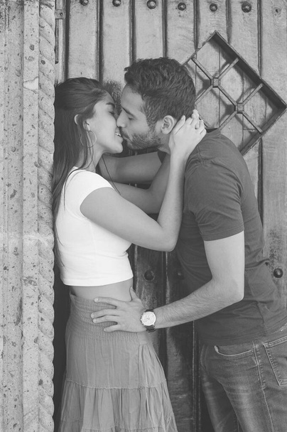 Couple in love outside a rustic house with wooden door. - Foto, Imagem