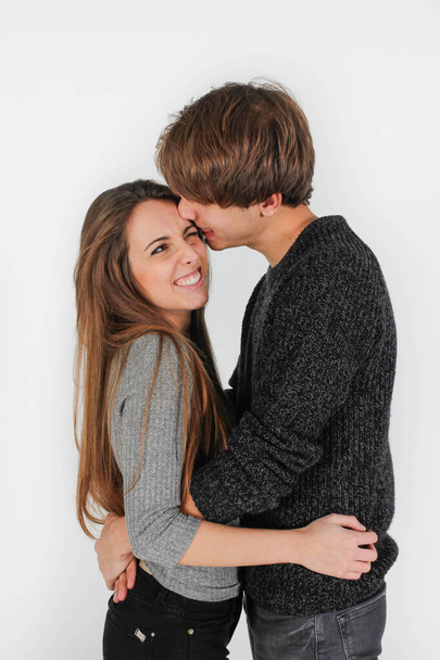 beautiful young couple cuddling, kissing and having fun - 写真・画像