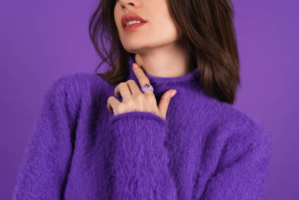 Young woman in a purple soft cozy sweater on the background of cute smiling cheerfully, in high spirits, confident smile, bright makeup with lipstick - Fotó, kép