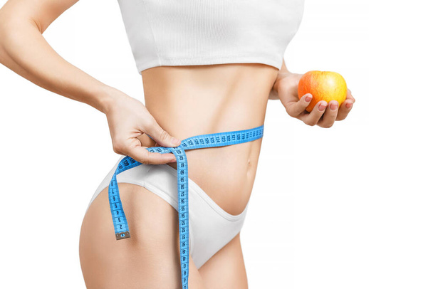 Woman measuring her slim body. Isolated on white background. Woman measuring her slim body isolated on white. - Fotografie, Obrázek