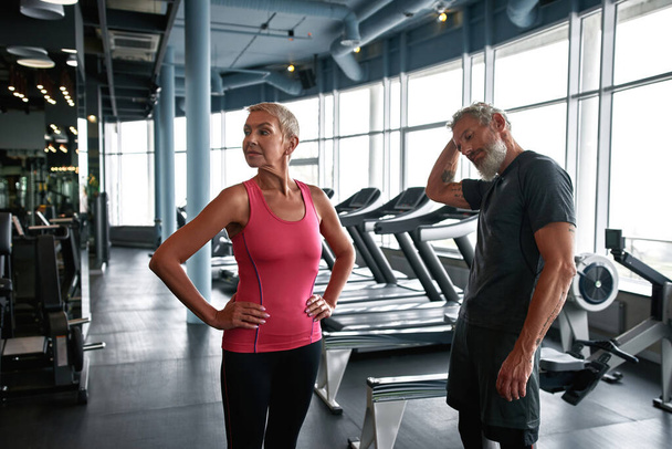 Attractive mature man and woman preparing for workout in gym - Φωτογραφία, εικόνα