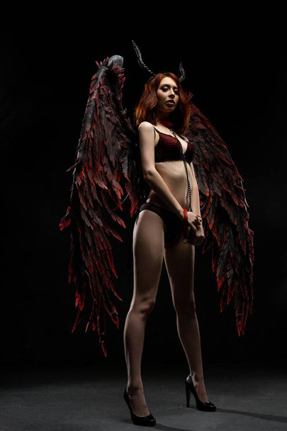 Sexy woman in provocative fallen angel costume - Foto, Imagen