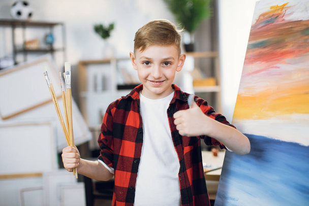 Boy searching for inspiration during lesson at art school - Фото, изображение