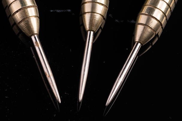 Three arrows dart tips on black with text space - Φωτογραφία, εικόνα