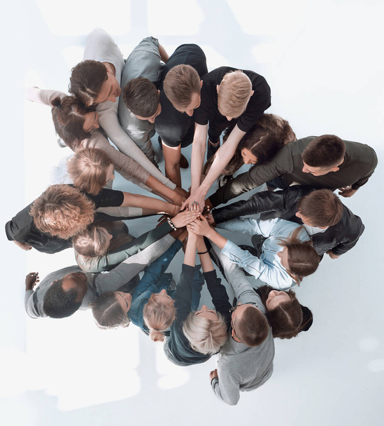 top view . a group of diverse young people showing their unity . - 写真・画像