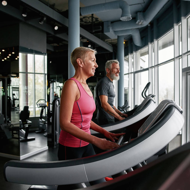 Elderly couple make healthy lifestyle choice to exercise in gym - Φωτογραφία, εικόνα