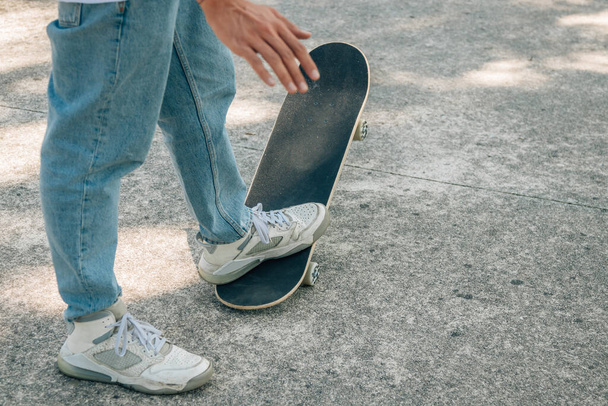 closeup of feet of young man with skateboard - Foto, Imagen