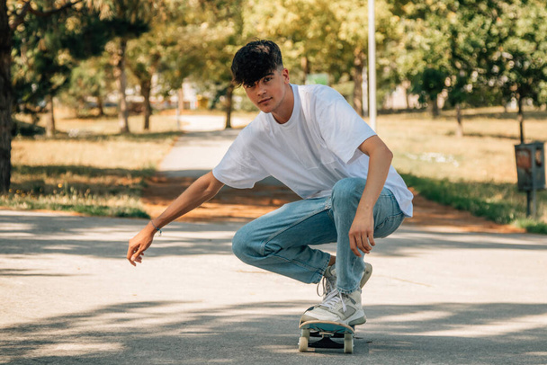 teenage boy with skateboard on the street - Photo, image