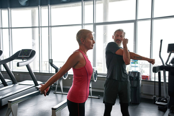 Middle-aged man and woman preparing for fitness class - Photo, image
