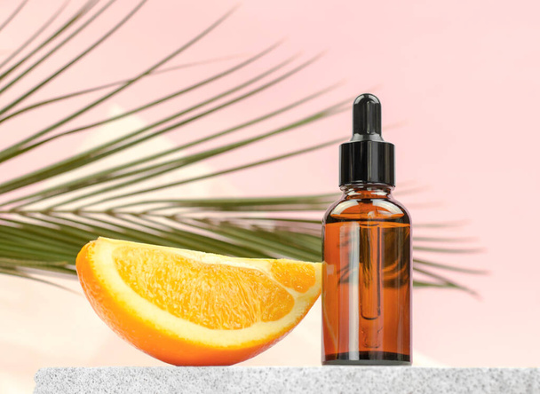 Orange oil in bottle with dropper and orange slice, selective focus - Foto, immagini