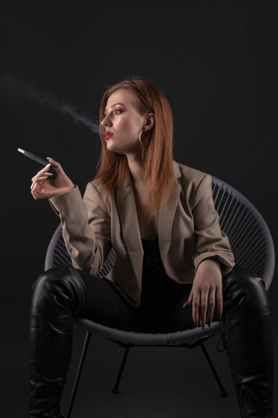 portrait of the beautiful young woman with a cigarette  - 写真・画像