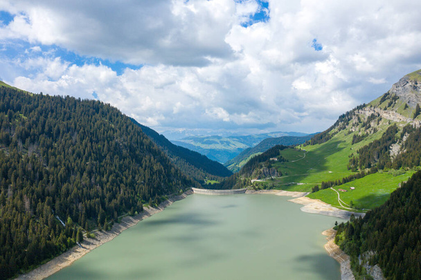 This landscape photo was taken in Europe, in France, towards Beaufort, in the Alps, in summer. We can see the Saint Guerin Dam, under the Sun. - Photo, Image