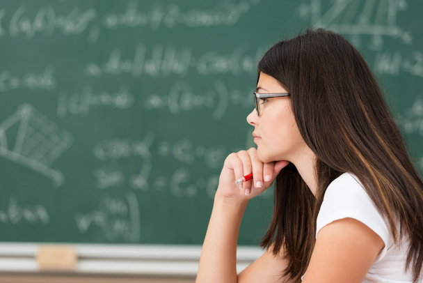 Thoughtful girl wearing glasses in class - Photo, Image