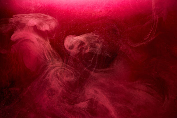 Pink smoke on black ink background, colorful fog, abstract swirling touch ocean sea, acrylic paint pigment underwater - Photo, image