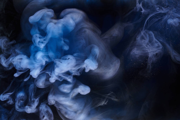 Blue smoke on black ink background, colorful fog, abstract swirling ocean sea, acrylic paint pigment underwater - Foto, Imagen