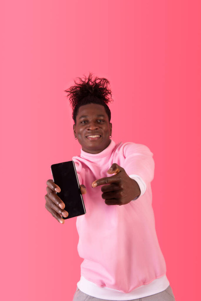 Excited afro american man pointing his smartphone with joy and confidence - Photo, Image