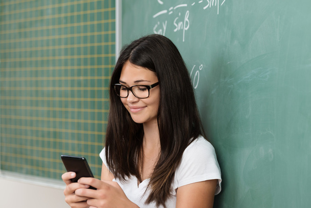 Young student or teacher reading a text message - Foto, afbeelding