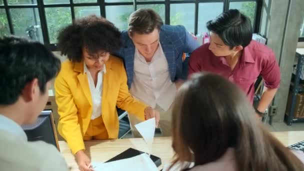 Multiracial coworkers' team and colleagues brainstormed, discussing marketing strategy, ideas collaboration, and business project planning at an office's conference table in staff meeting workplace. - Footage, Video