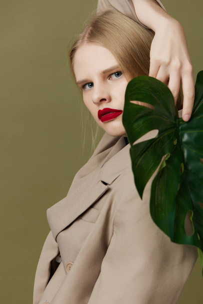 glamorous woman in coat red lips fashion palm leaf Lifestyle posing - Foto, Imagem