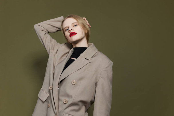 portrait of a woman with red lips coat bright makeup isolated background - 写真・画像