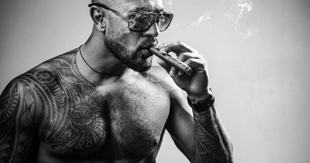 Brutal sportsman torso. Sport and fitness. Confidence and charisma. Sexy abs of tattoo man. Muscular macho man with athletic body. Vape - Photo, image