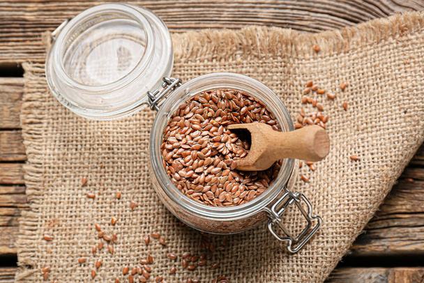 Jar with flax seeds on wooden background - Fotografie, Obrázek