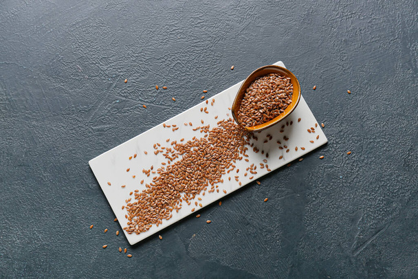 Bowl with raw flax seeds on dark background - Photo, Image