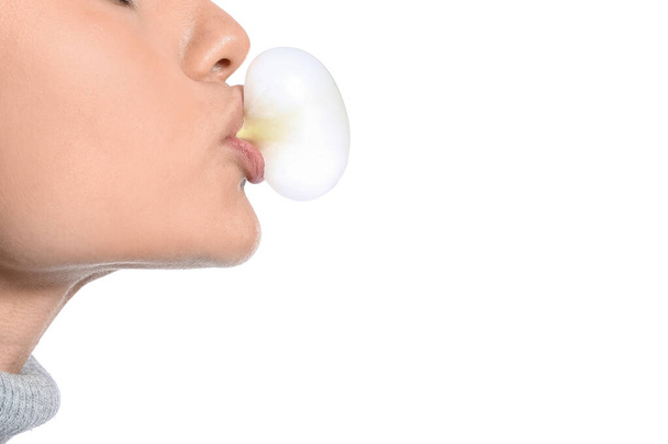 Young woman with chewing gum on white background, closeup - Photo, Image