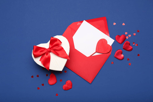 Gift box for Valentine's Day and envelope on blue background - Fotó, kép