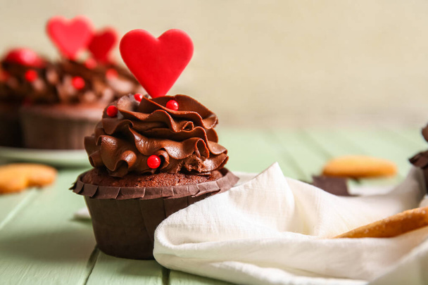Tasty chocolate cupcake for Valentine's day on wooden table, closeup - Фото, зображення