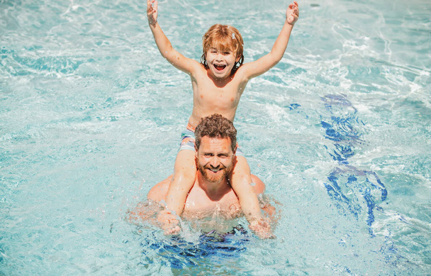 Father and son in pool. Summer weekend. Pool party. Child with dad playing in swimming pool. - Photo, image