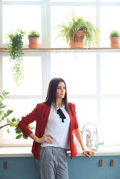 beautiful businesswoman in red jacket working in office - Foto, Bild