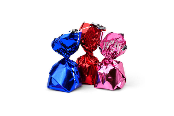 Chocolate candy with praline in color wrapper on white background. - Foto, imagen