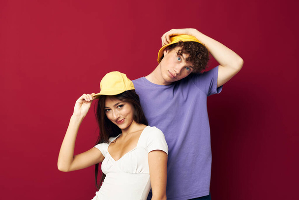 Man and woman in colorful t-shirts stylish clothes hats isolated background - Photo, Image