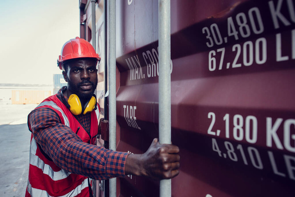 African-American  workers are opening containers for inspection and check that repairs have been completed in containers. - Fotografie, Obrázek
