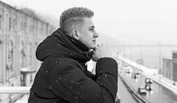 Portrait of young blonde guy Nordic appearance, lifestyle of young people. Handsome guy close up, winter day thinking about something - Zdjęcie, obraz