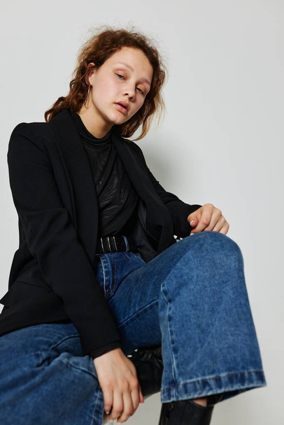 pretty woman black jacket jeans posing isolated backgrounds unaltered - Valokuva, kuva