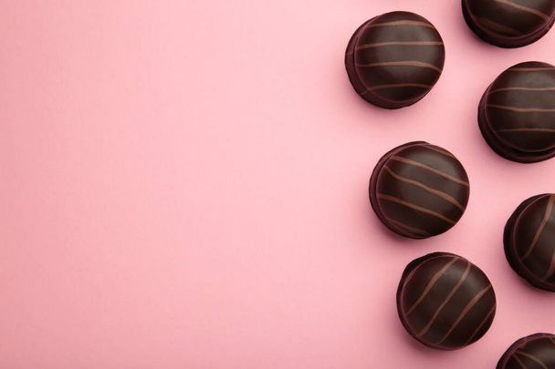 Chocolate sweets on pink background. Top view - Zdjęcie, obraz