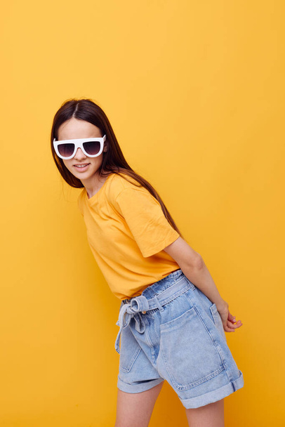 optimistic young woman hand gesture emotions summer style yellow background - Фото, зображення