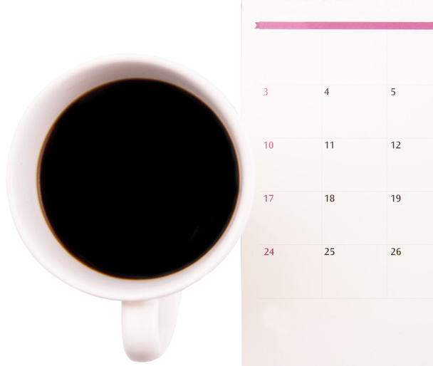 A mug of coffee and table day planner - Photo, Image