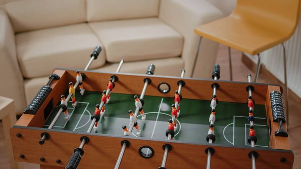 Close up of foosball game and bottles of beer with snacks on table - Foto, imagen