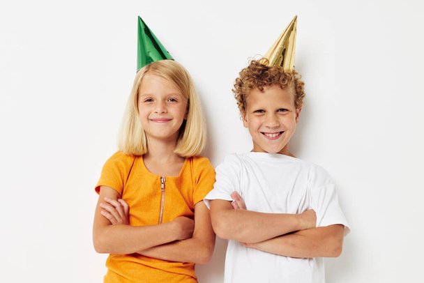 Cute stylish kids in multicolored caps birthday holiday emotion isolated background unaltered - Photo, image