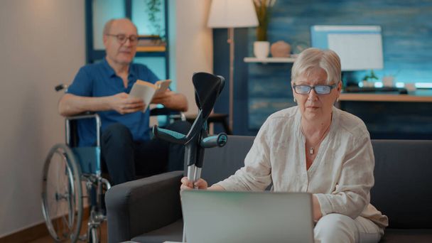 Senior woman using laptop to have online conversation - Photo, Image