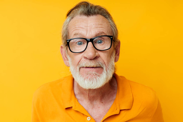 Portrait of happy senior man with a gray beard in glasses cropped view - Foto, Bild