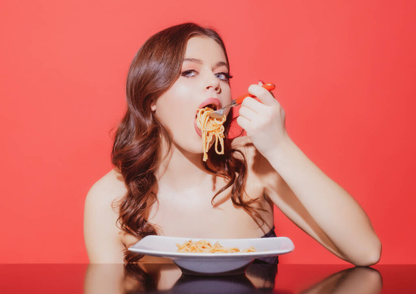 Food from Italia. Italian local cuisine. Girl eating pasta. Eating spaghetti with fork. - Photo, image